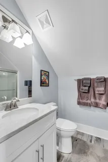a bathroom with a toilet a sink and mirror