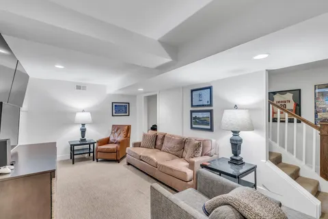 a living room with furniture and a lamp