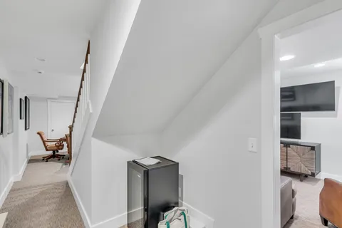 a view of a hallway with furniture and closet