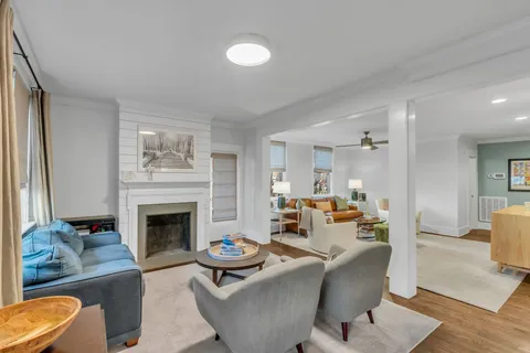 a living room with furniture and a fireplace