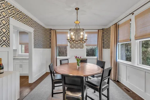 a view of a dining room with furniture window and wooden floor