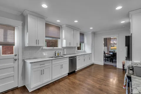 a large kitchen with a large counter top appliances and cabinets