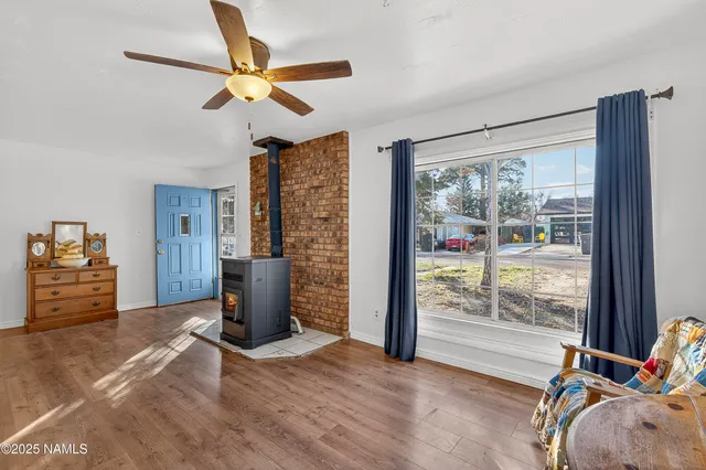 a view of an empty room with a fireplace and a window