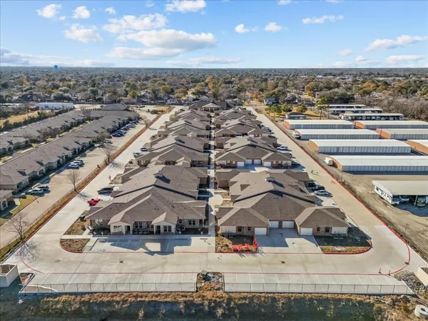 an aerial view of residential houses with outdoor space