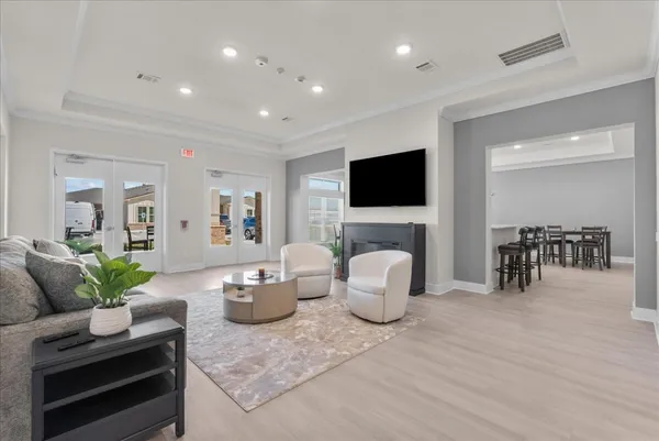 a living room with furniture and view of kitchen