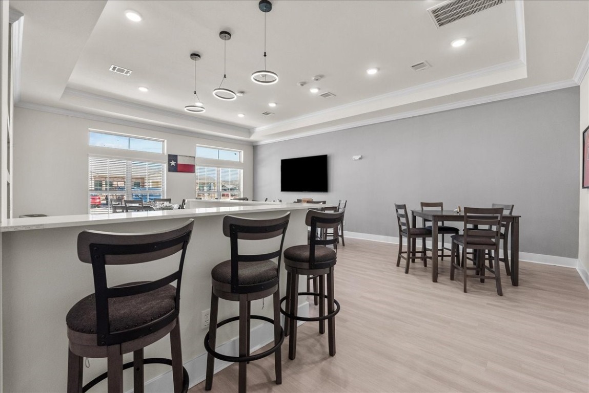 540 Hobbs Road, Unit D1 League City, TX 77573 - Photo 32 of 44 a kitchen with stainless steel appliances kitchen island granite countertop a table and chairs