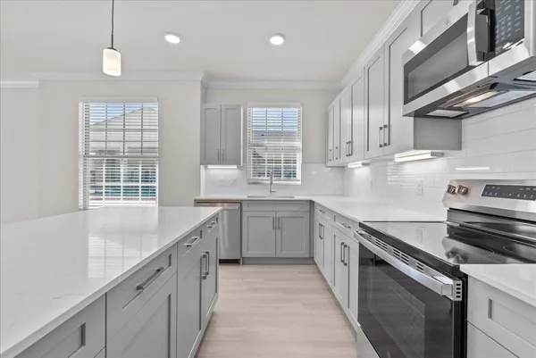 a kitchen with a sink stove and cabinets