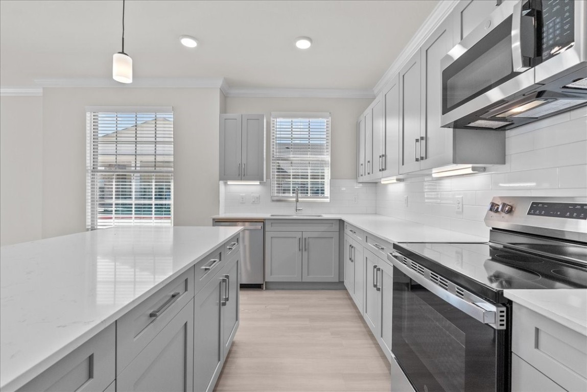 540 Hobbs Road, Unit D1 League City, TX 77573 - Photo 4 of 44 a kitchen with a sink stove and cabinets