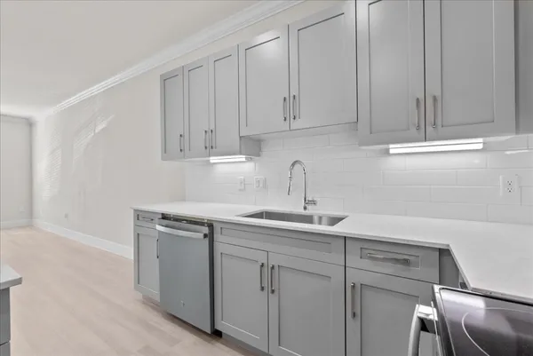 a kitchen with white cabinets and a sink