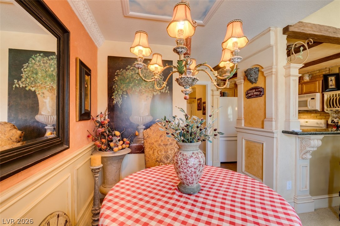 9325 West Desert Inn Road, Unit 244 Las Vegas, NV 89117 - Photo 18 of 55 Ornate ceiling fixtures and crown molding add grandeur to this inviting eat-in kitchen area.