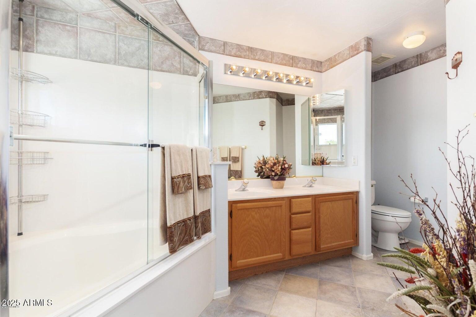 8841 South 51st Street, Unit 1 Phoenix, AZ 85044 - Photo 11 of 23 a bathroom with a bathtub sink and toilet