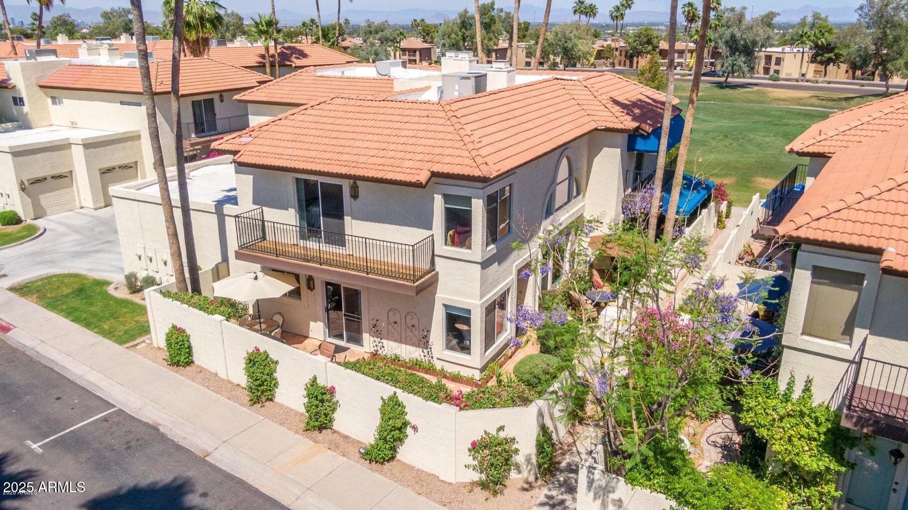 8841 South 51st Street, Unit 1 Phoenix, AZ 85044 - Photo 3 of 23 a aerial view of a house with a yard table and chairs