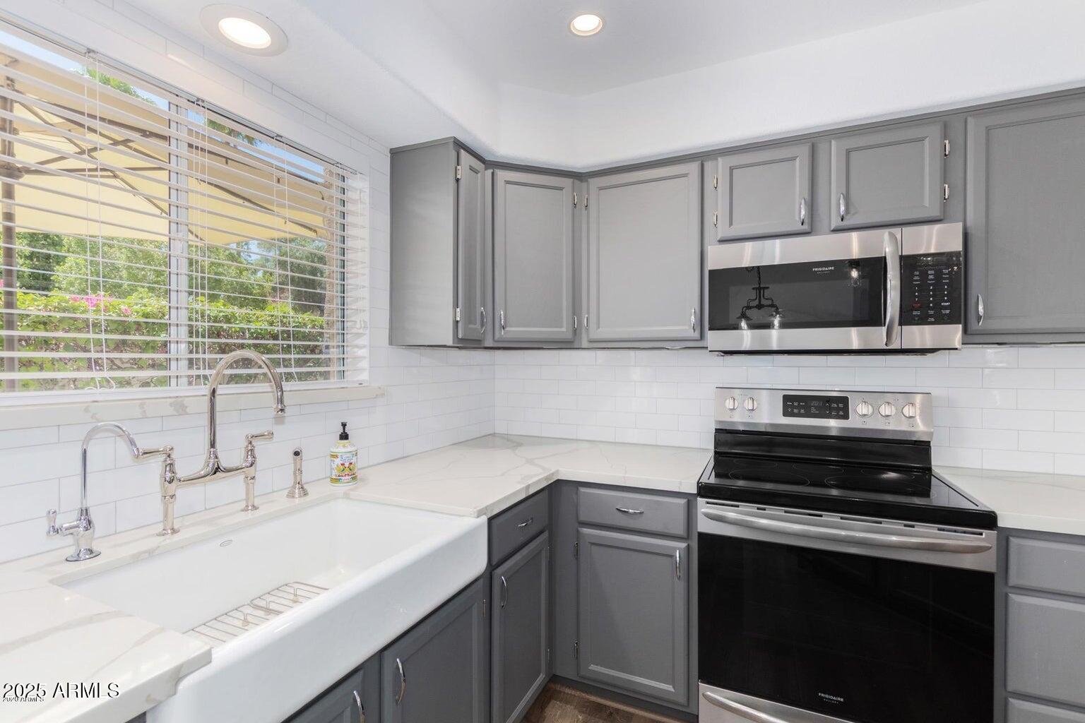 8841 South 51st Street, Unit 1 Phoenix, AZ 85044 - Photo 5 of 23 a kitchen with a sink stove and microwave