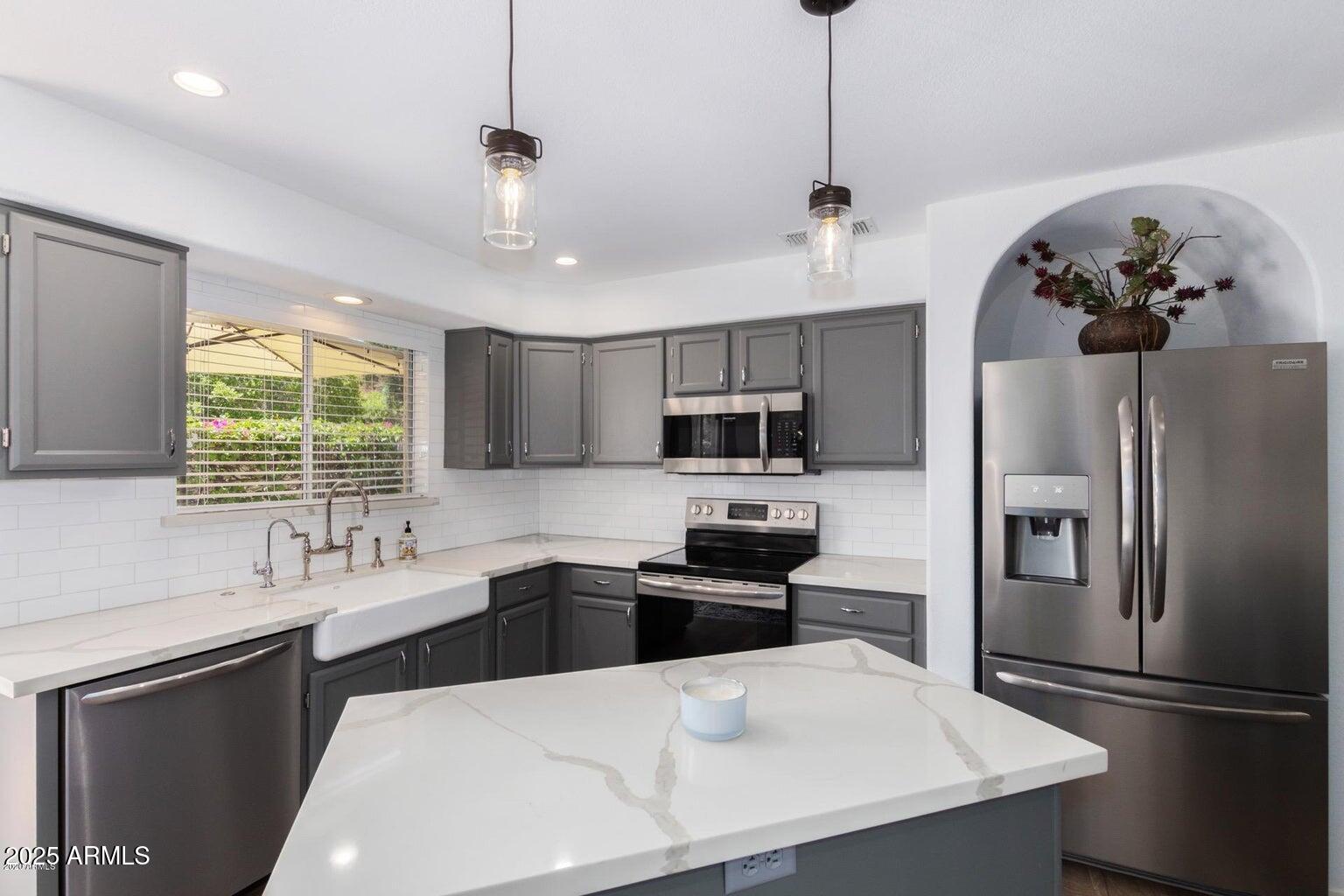 8841 South 51st Street, Unit 1 Phoenix, AZ 85044 - Photo 6 of 23 a kitchen with stainless steel appliances a sink stove and refrigerator