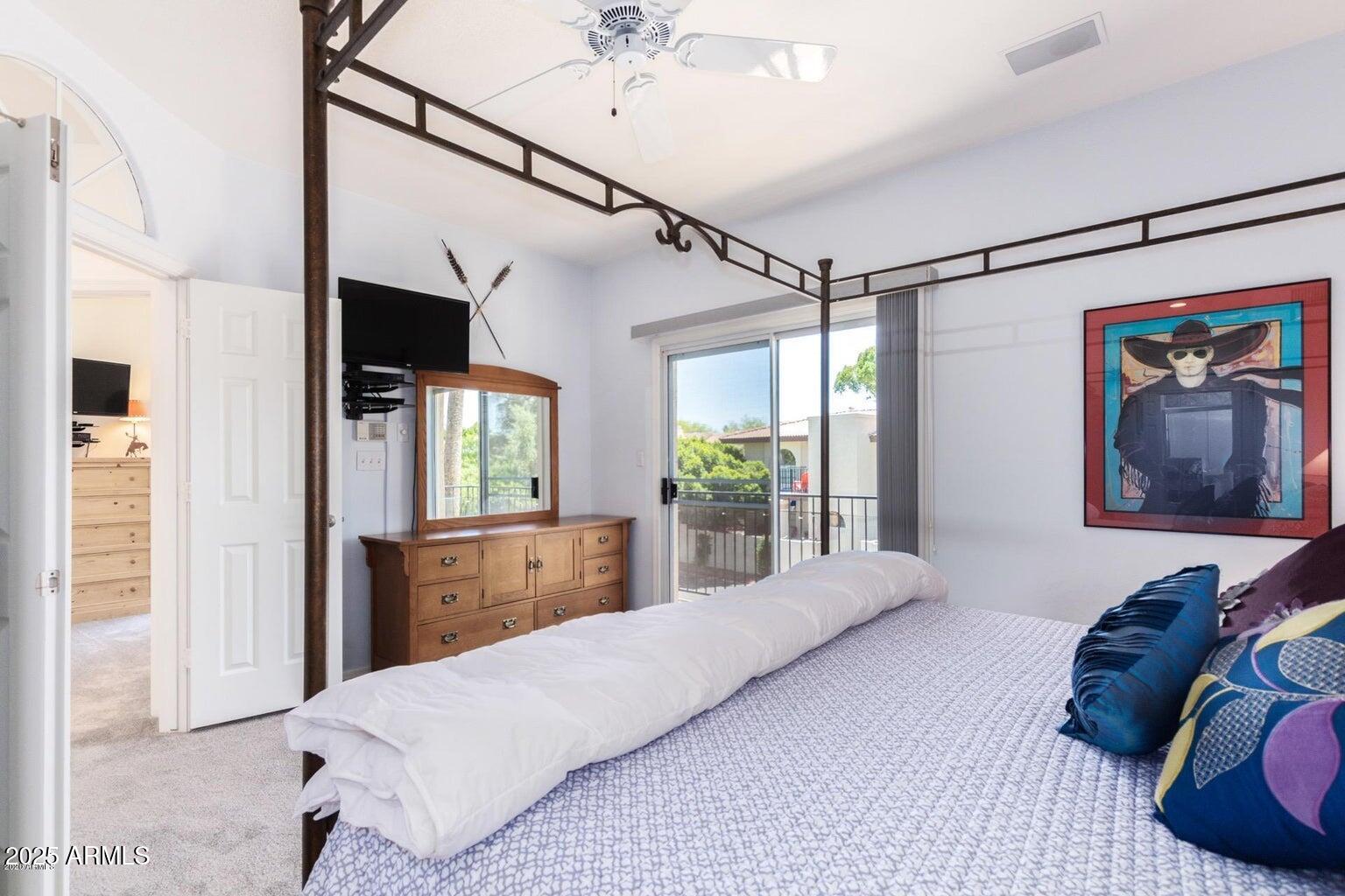 8841 South 51st Street, Unit 1 Phoenix, AZ 85044 - Photo 8 of 23 a bedroom with a bed and a chandelier