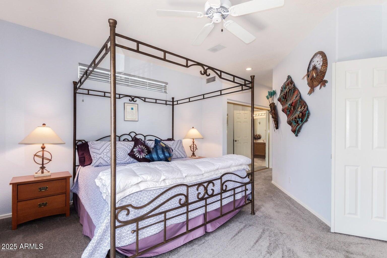 8841 South 51st Street, Unit 1 Phoenix, AZ 85044 - Photo 9 of 23 a bedroom with a bed and a chandelier