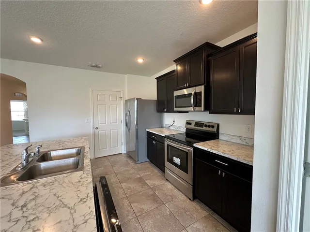 an empty room with closet and windows