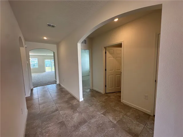 a view of a big room with windows and fireplace