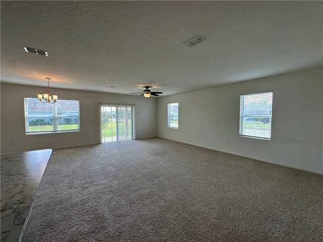 a large kitchen with stainless steel appliances kitchen island a stove a refrigerator a oven and a sink with large countertops