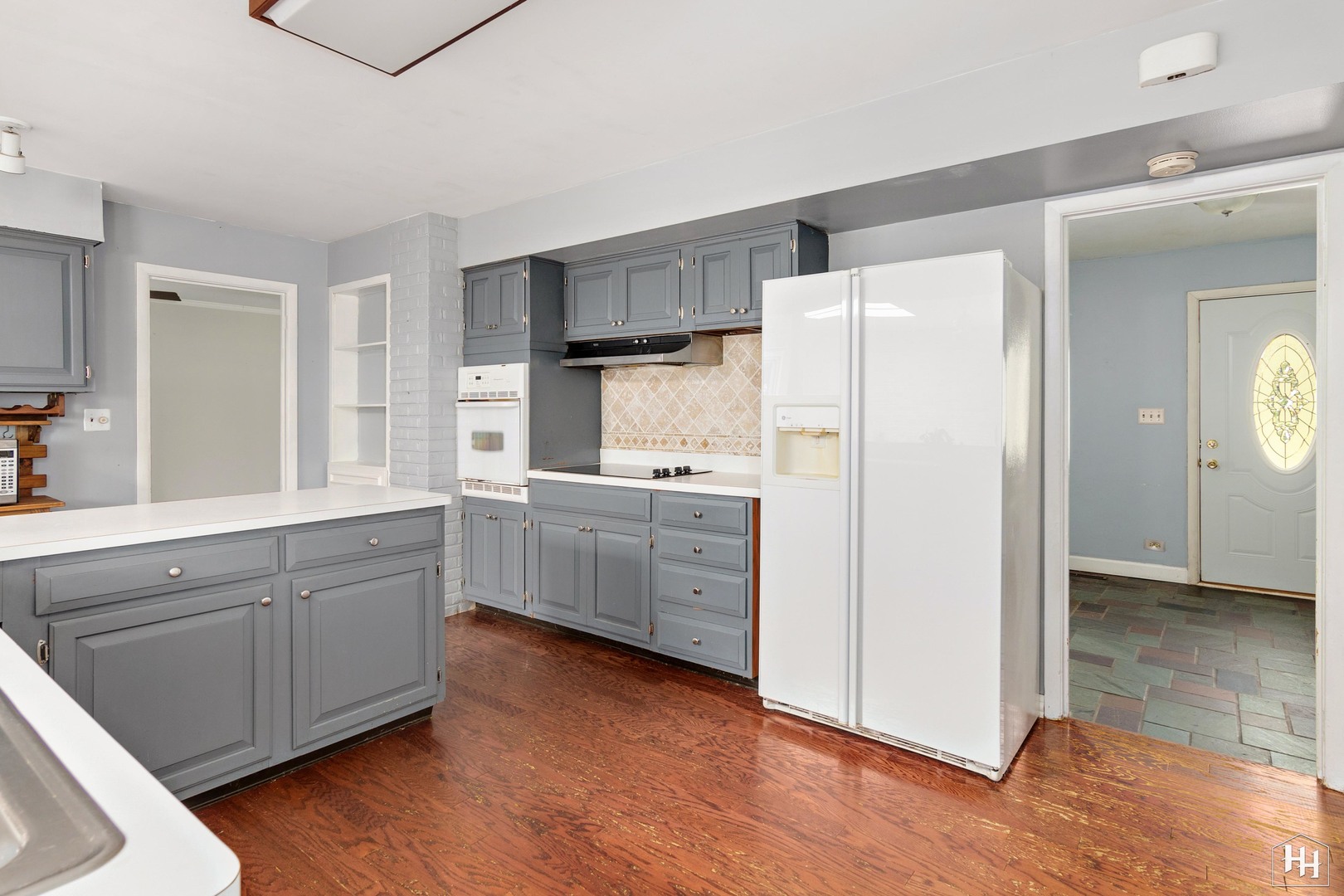 239 Brookbridge Road Trout Valley, IL 60013 - Photo 9 of 24 a kitchen with white cabinets and white appliances