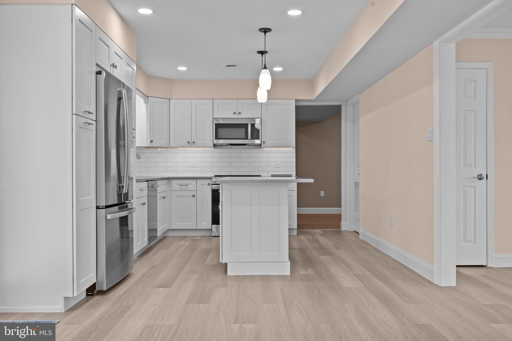 1838 Sheri Road Bensalem, PA 19020 - Photo 11 of 43 a kitchen with kitchen island a sink stainless steel appliances and cabinets