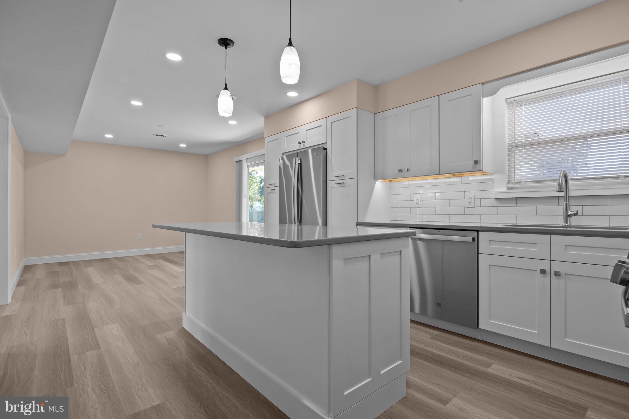 1838 Sheri Road Bensalem, PA 19020 - Photo 12 of 43 a kitchen with kitchen island a counter top space a sink stainless steel appliances and cabinets