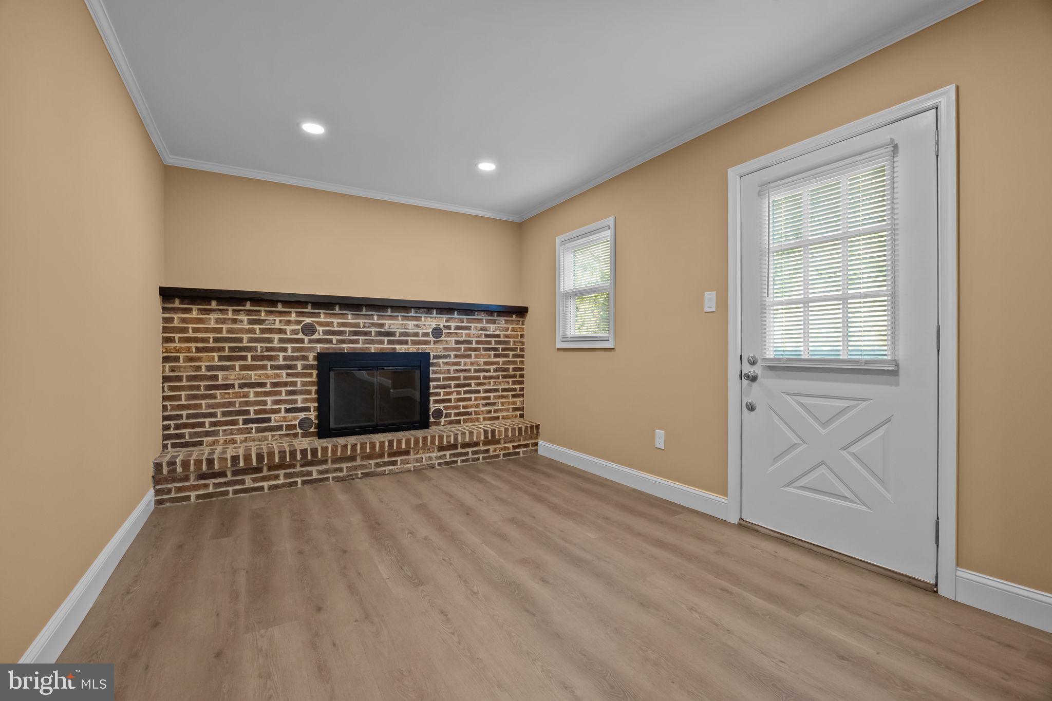 1838 Sheri Road Bensalem, PA 19020 - Photo 19 of 43 an empty room with wooden floor and fireplace