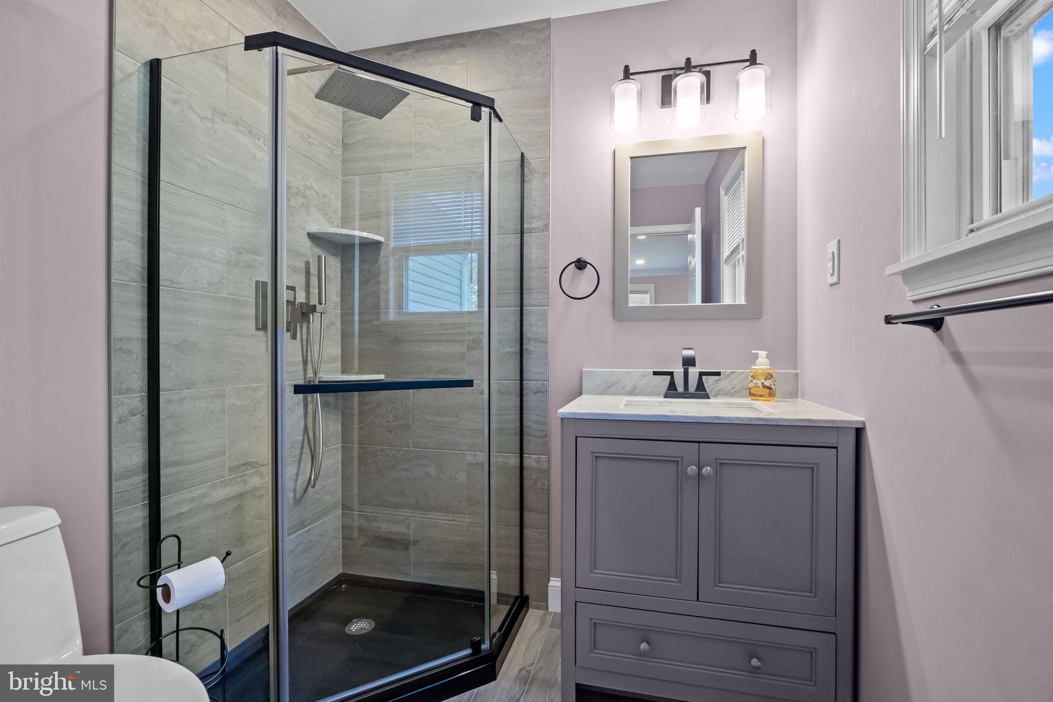 1838 Sheri Road Bensalem, PA 19020 - Photo 25 of 43 a bathroom with a shower sink and mirror