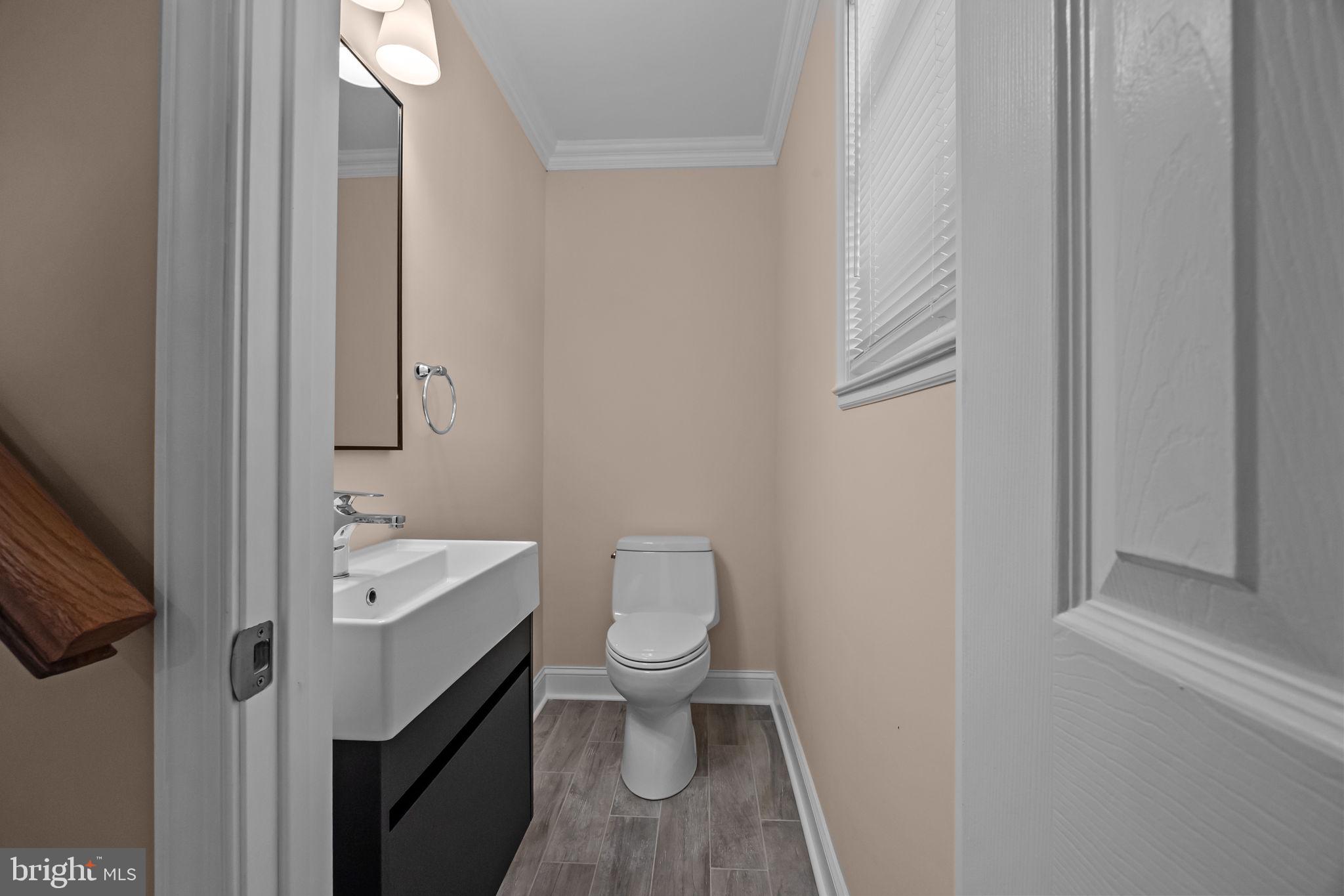 1838 Sheri Road Bensalem, PA 19020 - Photo 7 of 43 a bathroom with a toilet a sink and a mirror