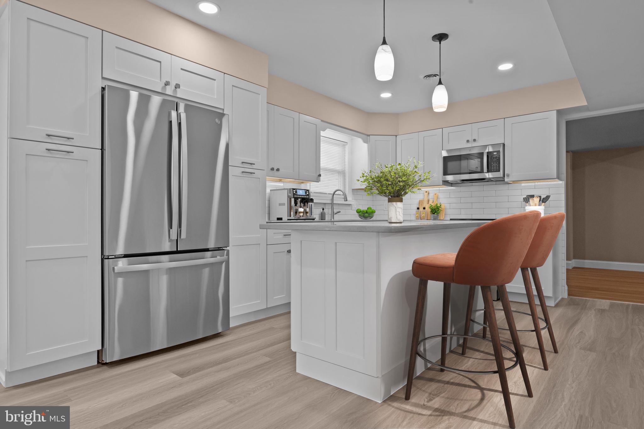 1838 Sheri Road Bensalem, PA 19020 - Photo 10 of 43 a kitchen with stainless steel appliances a refrigerator and a dining table