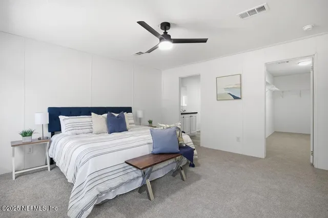 a bedroom with a bed and a ceiling fan