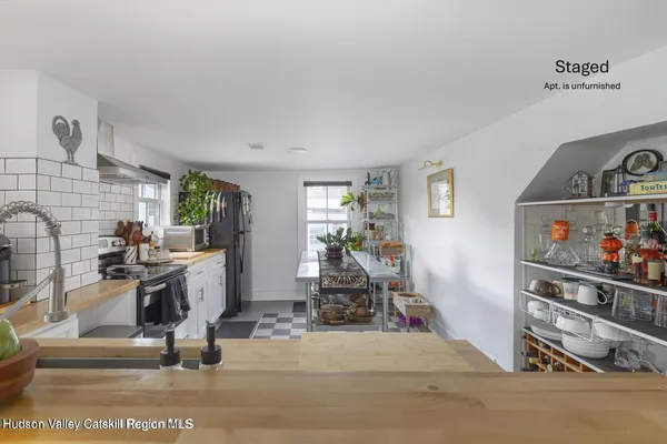 a view of a livingroom with workspace and a window