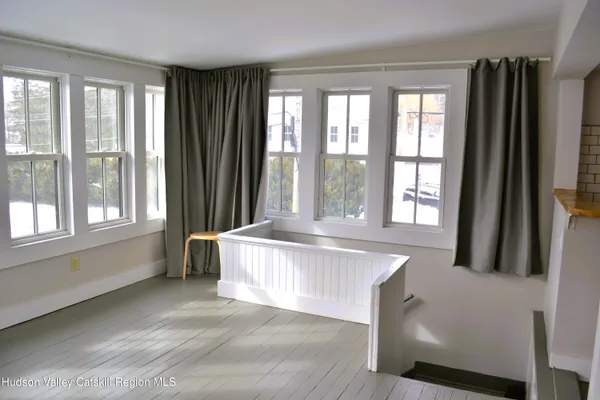 a spacious bedroom with a large window and a bed