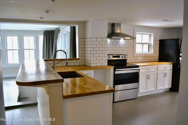 a kitchen with a stove a sink and a refrigerator