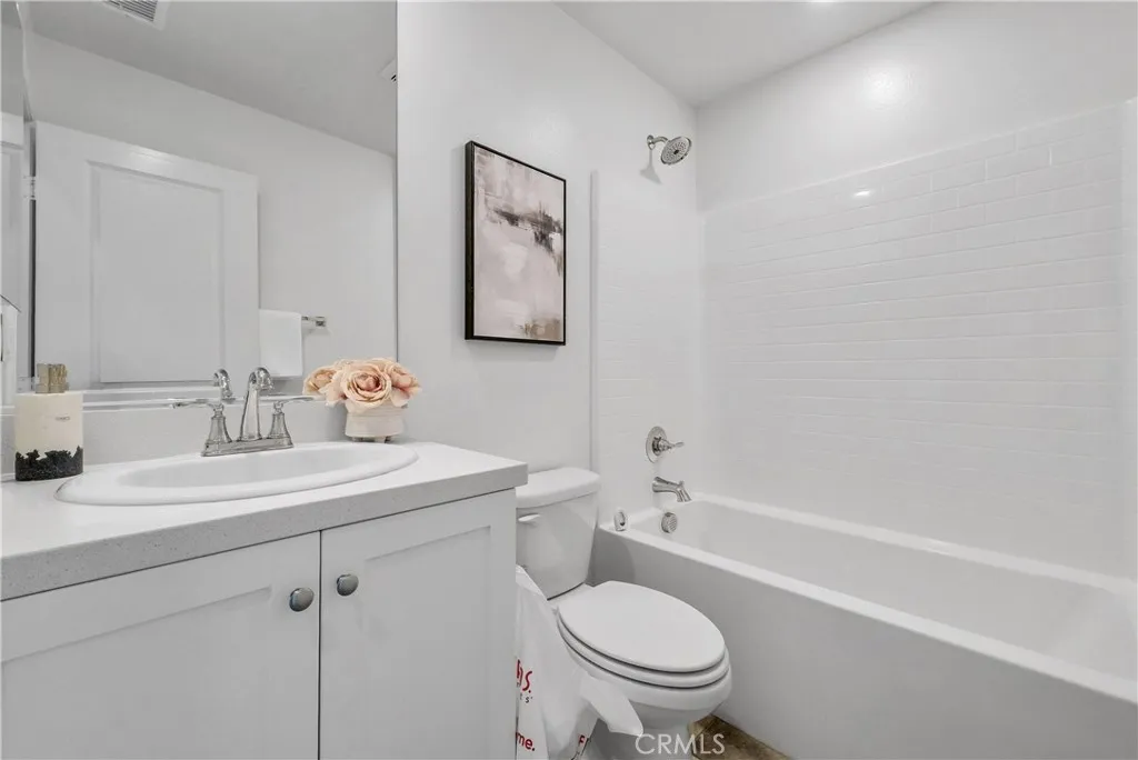 5584 Kate Way, Unit 10 Fontana, CA 92335 - Photo 11 of 42 a bathroom with a sink toilet and shower