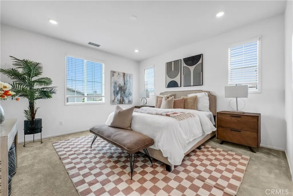 5584 Kate Way, Unit 10 Fontana, CA 92335 - Photo 14 of 42 a bedroom with a bed and a potted plant