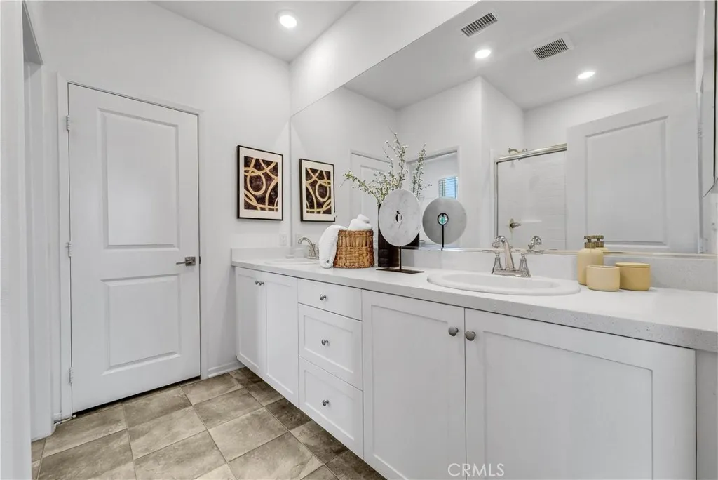 5584 Kate Way, Unit 10 Fontana, CA 92335 - Photo 16 of 42 a bathroom with a sink a mirror and a toilet