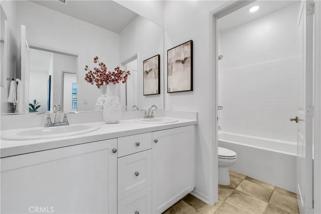 5584 Kate Way, Unit 10 Fontana, CA 92335 - Photo 20 of 42 a bathroom with a sink a toilet and shower