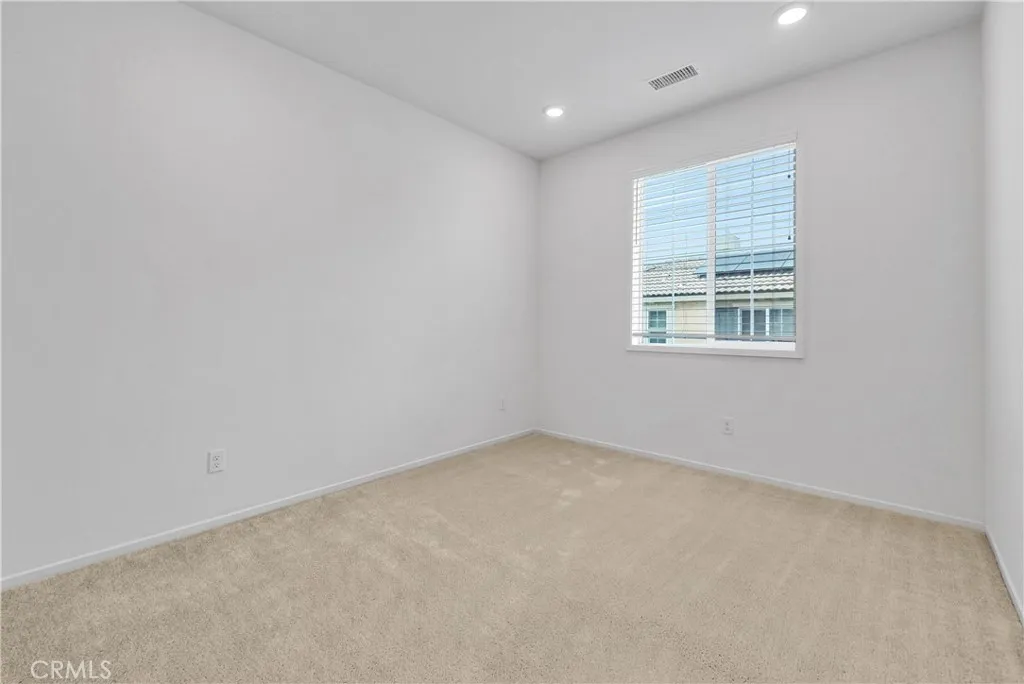 5584 Kate Way, Unit 10 Fontana, CA 92335 - Photo 21 of 42 an empty room with a window