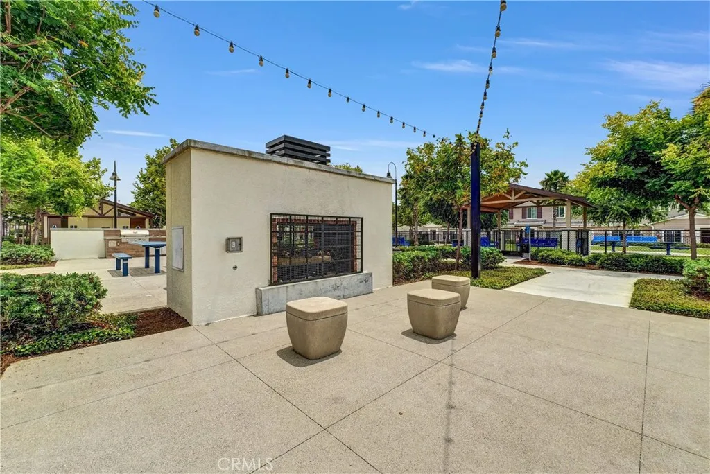 5584 Kate Way, Unit 10 Fontana, CA 92335 - Photo 35 of 42 a view of a patio with chairs and potted plants