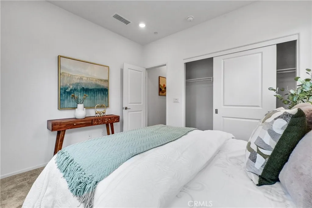 5584 Kate Way, Unit 10 Fontana, CA 92335 - Photo 10 of 42 a bedroom with a bed and a potted plant