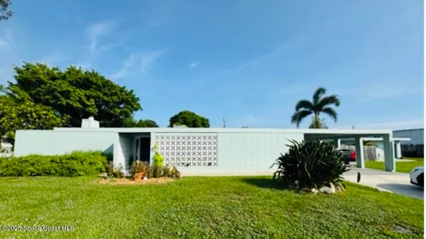 a view of a house with a yard and sitting area