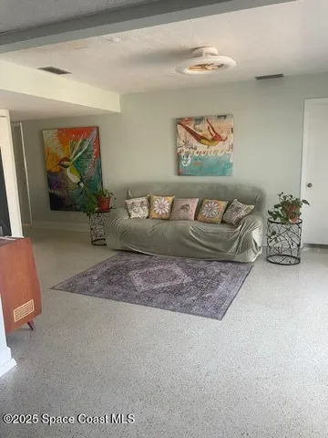 a view of a house with a yard and sitting area