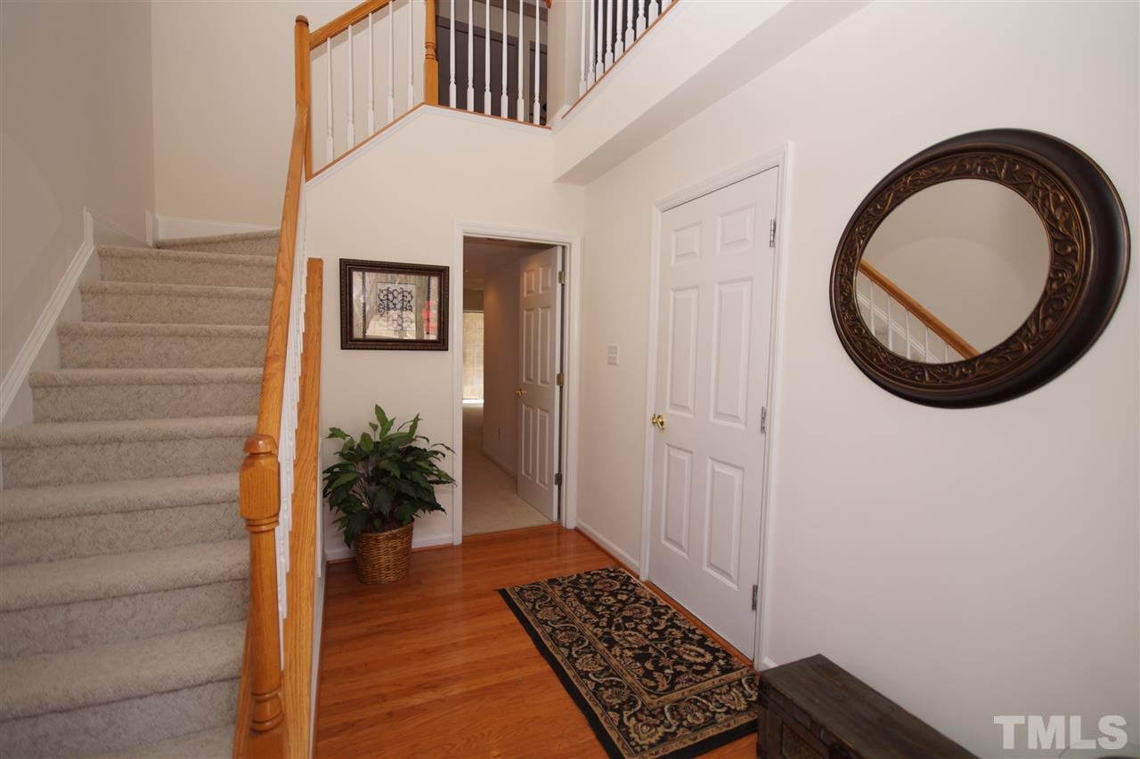5202 Echo Ridge Road Raleigh, NC 27612 - Photo 2 of 22 a view of a hallway with wooden floor and entryway