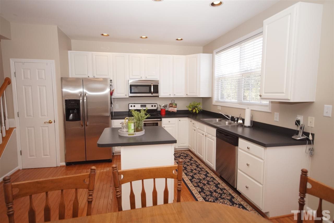 5202 Echo Ridge Road Raleigh, NC 27612 - Photo 11 of 22 a kitchen with stainless steel appliances granite countertop a refrigerator sink and stove