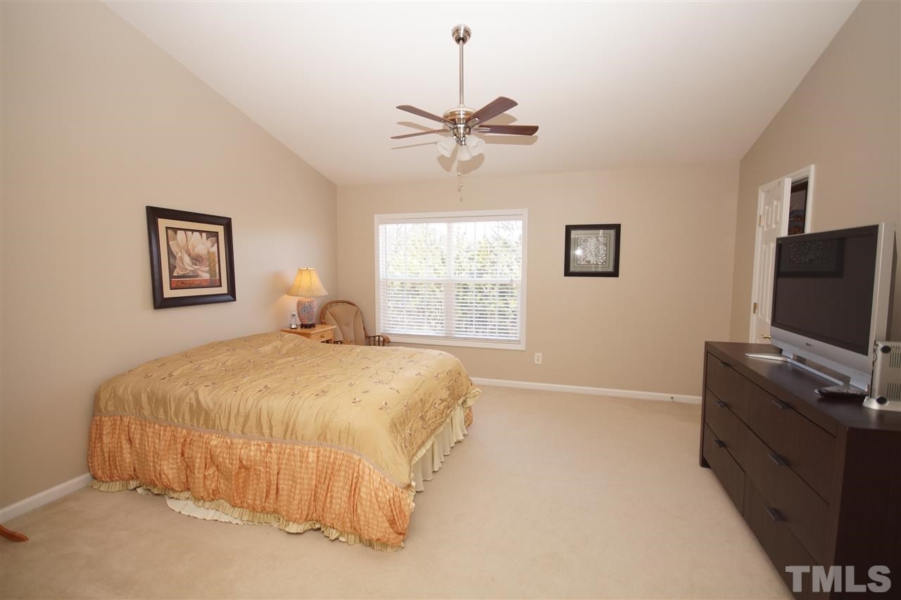 5202 Echo Ridge Road Raleigh, NC 27612 - Photo 12 of 22 a bedroom with a bed and a flat screen tv