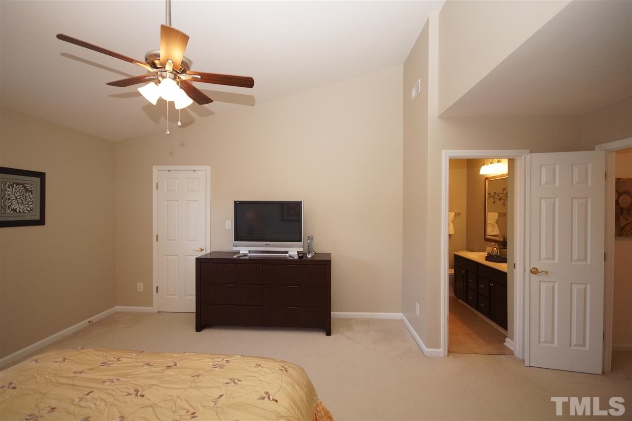 5202 Echo Ridge Road Raleigh, NC 27612 - Photo 13 of 22 a living room with furniture and a flat screen tv