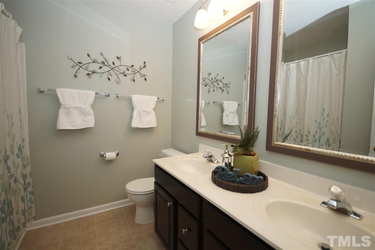 5202 Echo Ridge Road Raleigh, NC 27612 - Photo 14 of 22 a bathroom with a sink double vanity and a mirror