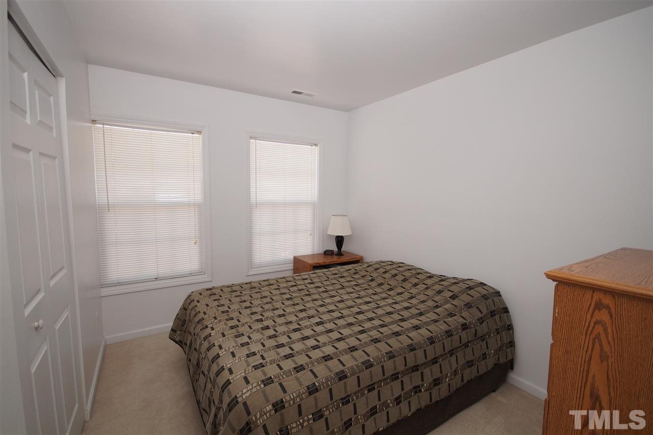 5202 Echo Ridge Road Raleigh, NC 27612 - Photo 15 of 22 a bedroom with a bed and window