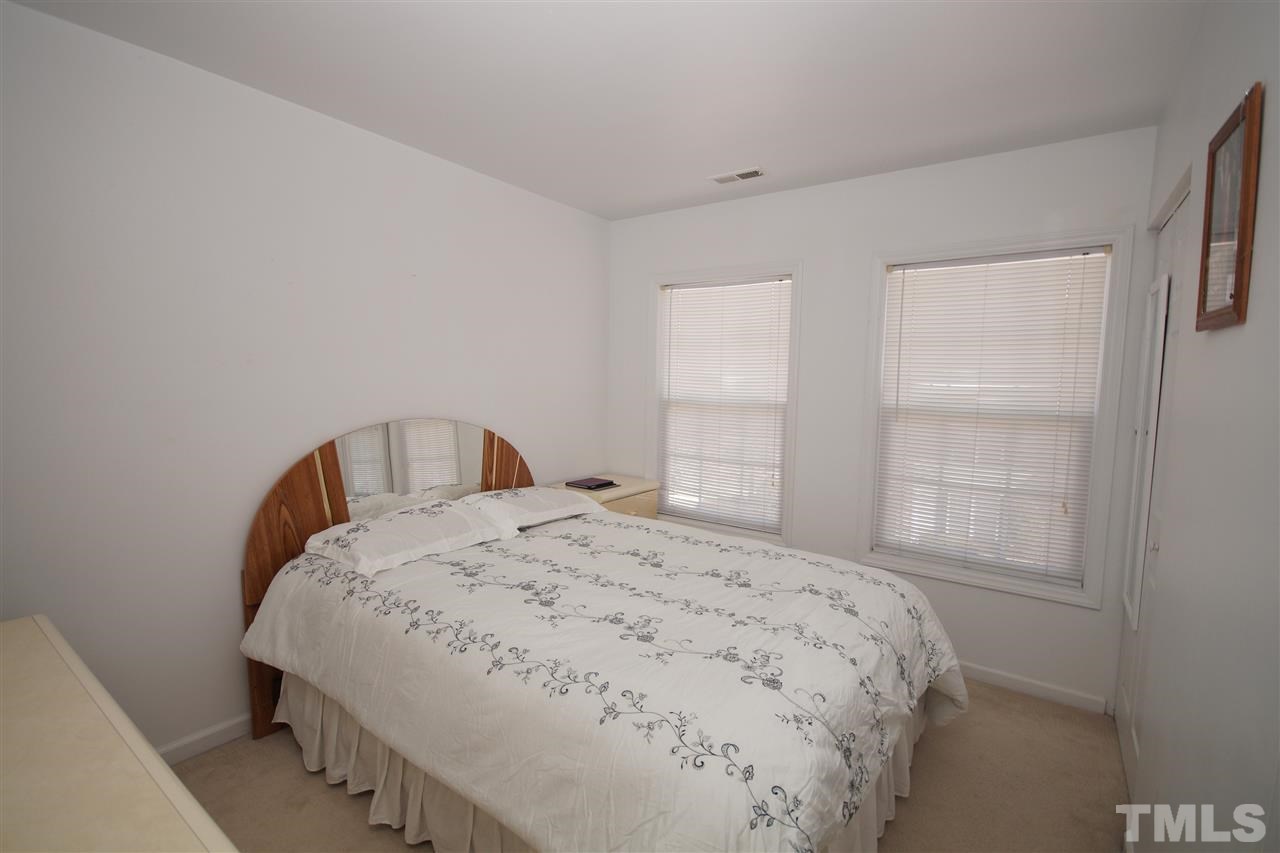 5202 Echo Ridge Road Raleigh, NC 27612 - Photo 16 of 22 a bedroom with a bed and a window